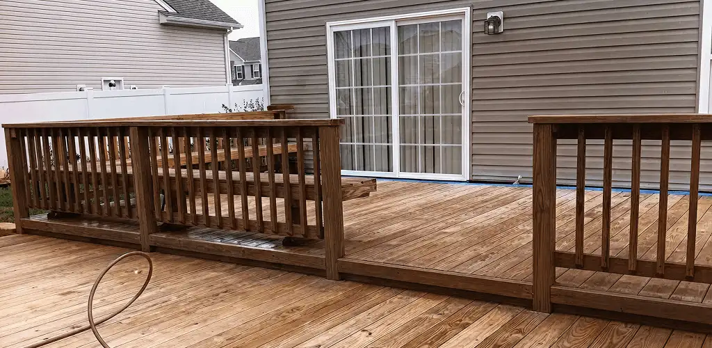 Deck sealing service protecting a backyard wood deck and railings in Newark, NJ