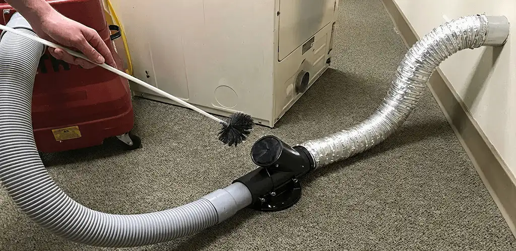 Dryer vent cleaning service removing lint from a dryer duct connection in Newark, NJ
