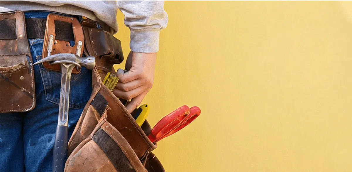 Handyman with tool belt ready for home repairs and maintenance in Newark, NJ