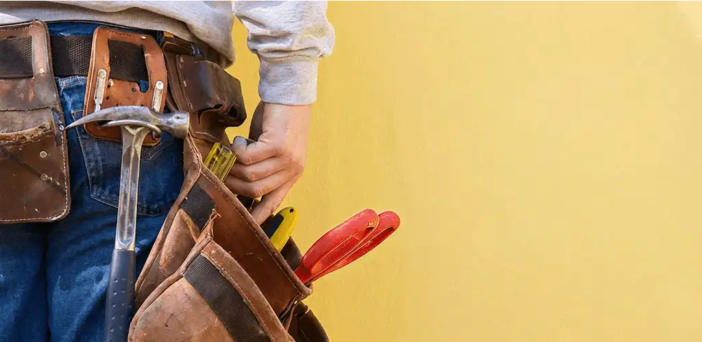 Handyman with tool belt ready for home repairs and maintenance in Newark, NJ