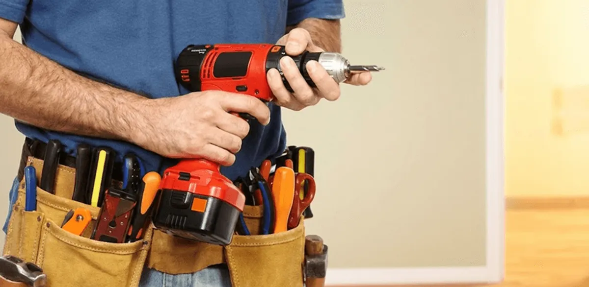Handyman holding a power drill for home repairs and installations in Newark, NJ